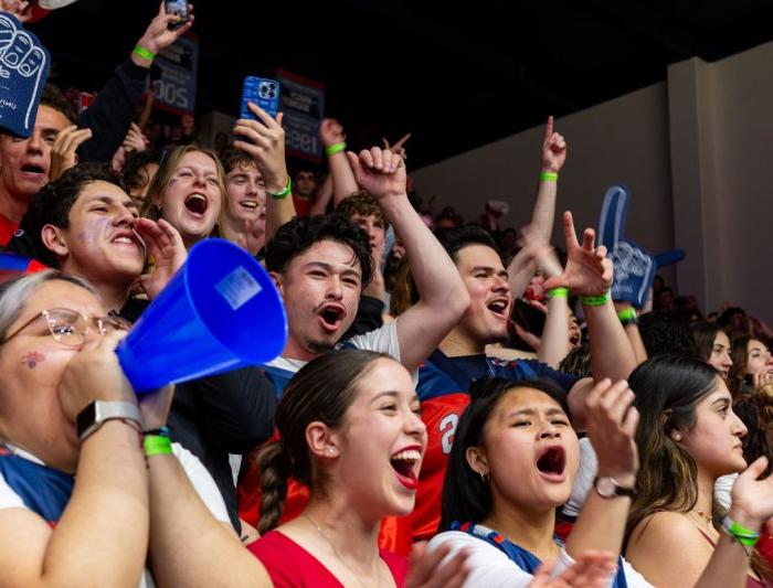 Students cheering at a basketball game